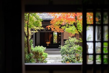 Japanese garden courtyard view through a traditional window. Autumn colors