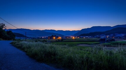 Peaceful village at dawn, hazy mountain backdrop