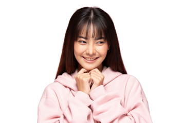 Asian Young smiling woman in pink hoodie holding hands near chin with shy joyful expression and soft lighting