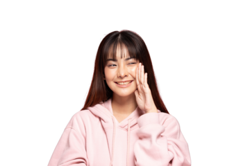 Asian smiling young woman wearing pink hoodie whispering with hand near mouth, portrait, casual clothing, cheerful expression, isolated on transparent background