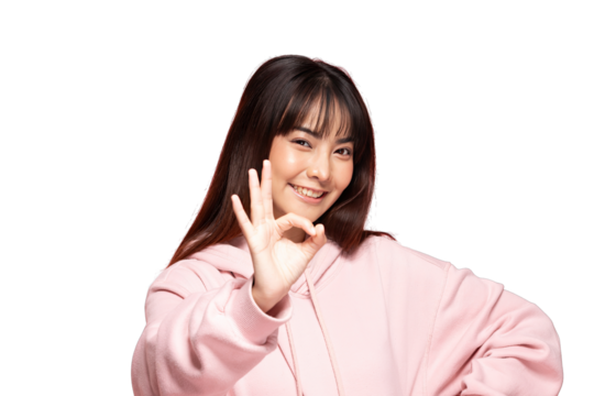 Asian young woman in pink hoodie making okay gesture and smiling confidently with casual pose and warm expression - Powered by Adobe