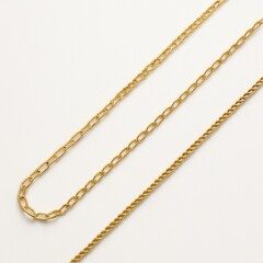 Delicate gold chain necklace arranged in gentle S curve on pure white background