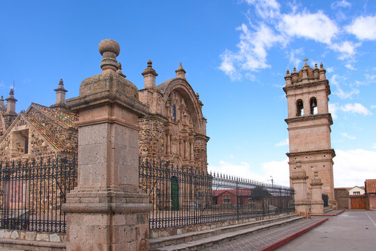 The Temple of Santiago Ap&oacute;stol of Lampa, with its 35-meter tower beside it. The church was built with pink volcanic stone (sillar) using the calicanto technique.