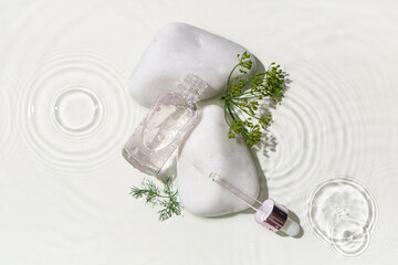 Composition with bottle of dill cosmetic product and spa stones in water on white background,...
