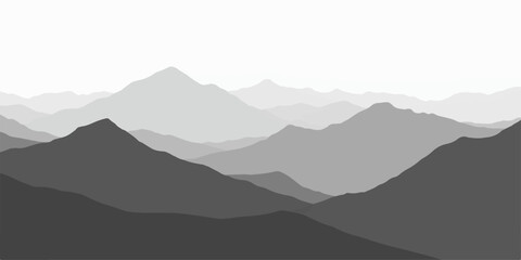 Mountain landscape view with peaks and misty blue morning sky