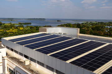 High-quality photo of solar panels mounted on a contemporary building rooftop, showcasing clean energy technology and sustainable urban infrastructure.