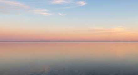 Fototapeta premium Calm ocean horizon at sunset with pastel sky reflection
