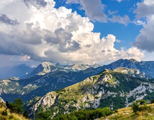 Naklejka premium Sunny mountain panorama with layered peaks under a cloudy sky