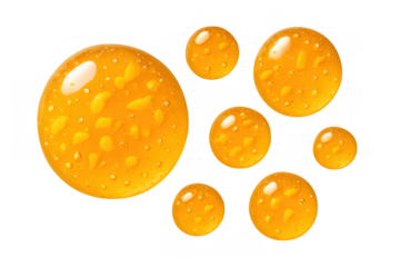 Golden yellow viscous liquid drops with bubbles floating in a transparent background, sweet golden honey texture
