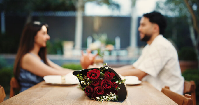 Love, couple and date with roses in restaurant for romantic gift, anniversary lunch and bonding. Celebration, people and relax with flower bouquet for appreciation, healthy relationship or connection