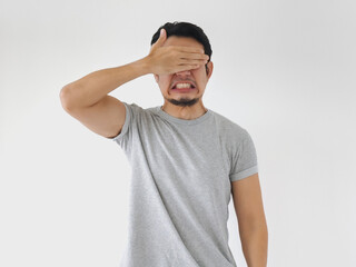 Man with a beard and a shirt on is looking away from the camera