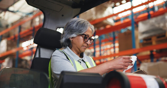 Clipboard, forklift and woman in warehouse for shipping, delivery schedule and inventory list. Factory, machine and mature person with paperwork for supply chain, distribution or logistics inspection