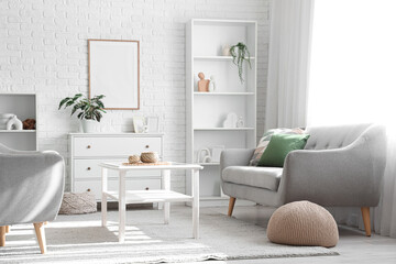 Soft knitted pouf and comfortable grey sofa in living room