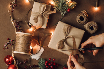 Top view of woman hands preparing christmas gift