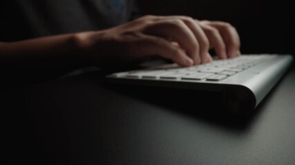 Close-up man typing on computer keyboard with hands and fingers. Macro soft focus dolly shot. Computer programming, text chat online messaging and online marketing business concept. Glean - Powered by Adobe