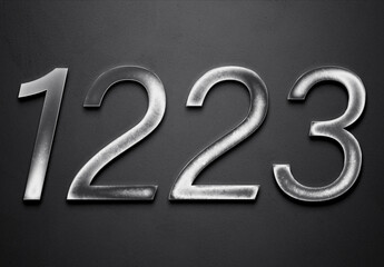 Chrome metal 3D number design of 1223 on grey background.