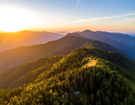 Aerial view of a mountain range at golden hour during sunset