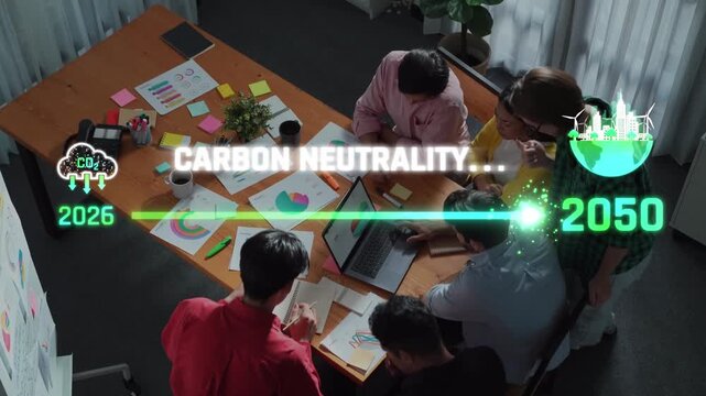 A diverse team collaborates in a modern office space, focused on achieving carbon neutrality by 2050 through innovative strategies and planning sessions. Raster