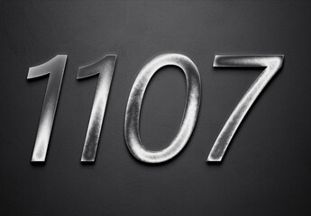Chrome metal 3D number design of 1107 on grey background.