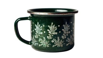 A green enamel mug with white leaf pattern and silver rim isolated on a black background studio shot