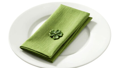 Green napkin with clover decoration on white plate for festive dining table setting