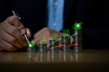 Businessman putting down money, pointing with pen and showing candlestick symbol for investing, finance, saving money, interest rate or dividend investment, business growth concept.