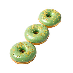 Three green glazed donuts with golden sprinkles arranged in a row on a white background