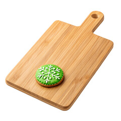 Green snowflake cookie on wooden cutting board with natural texture and holiday theme