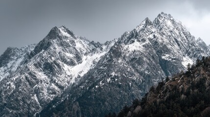 Snow Covered Mountain Peaks Under Cloudy Sky