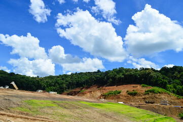 Fototapeta premium Sky and mountains under construction of reservoir