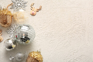 Composition with disco balls and Christmas decor on white grunge background, closeup