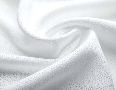 Close-up of pristine white fabric with intricate textures and subtle shadows. The delicate folds create a sense of softness and flow