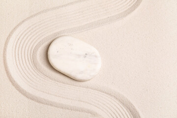 Composition with spa stone and lines on sand as background, closeup. Zen concept