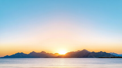 Fototapeta premium Soft pastel sunrise over mountain silhouette and calm sea, peaceful light