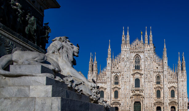 Duomo di Milano facade with blue sky background. Gothic architecture facade of Milan Duomo in Italy. Duomo di Milano. Front view of Milan Cathedral Duomo. Milan city.