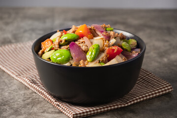 Spicy Thai Stir-Fried Pork with Stink beans in a Black Bowl