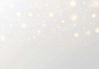 Fototapeta premium Glittering golden dust floats across a soft bokeh background with radiant highlights and sparkling flare. Twinkling yellow particles and shimmering blur create magical Christmas and New Year visuals.