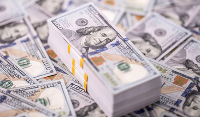 Stack of dollars and cash with a money background. US dollars money and banknotes. Pile of 100 USD bills. American hundred-dollar notes. Pattern of money. Cash and credit theme. Money dollars.