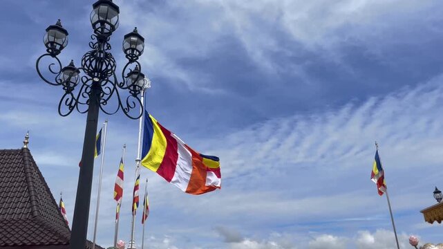 Buddhist flag waving in high sky in a temple