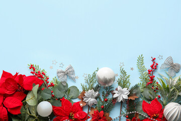 Obraz premium Composition with Christmas poinsettia flowers and decorations on blue background