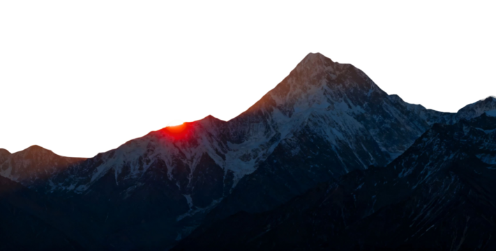 Sunrise illuminating the peak of a snow-covered mountain range