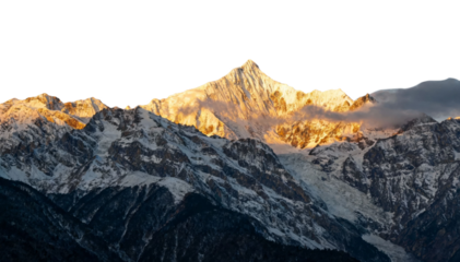 Snow-capped mountain peaks illuminated by golden sunlight at sunrise or sunset