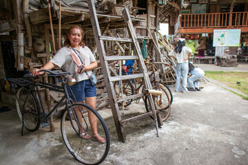 Obraz premium Woman Standing Beside Wooden Stilt Houses in Thailand