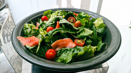 a plate of salmon and vegetable salad
