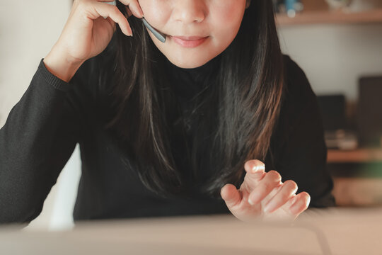Close up of woman wearing headset microphone for customer service support or telecommunication. Concept of online communication, call center, remote work, business service, and consulting - Powered by Adobe
