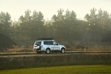 Fototapeta premium Traveling car with rooftop cargo box on highway