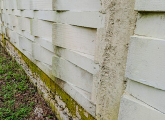 Textured white concrete block wall with geometric openings