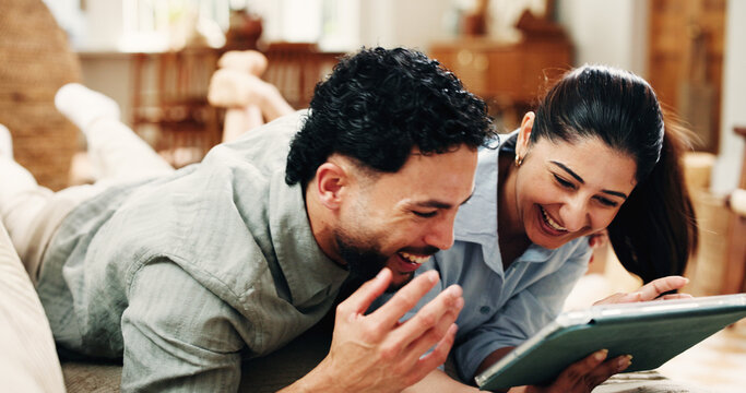 Tablet, couch and couple laughing with movie, watch comedy show or online subscription website. Love, weekend bonding and happy people relax with comic film, streaming video together or tech in home - Powered by Adobe