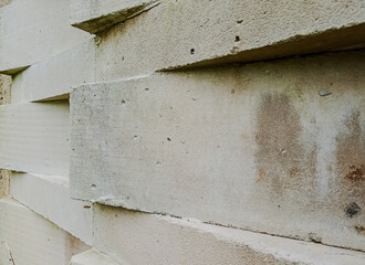 Textured white concrete block wall with geometric openings