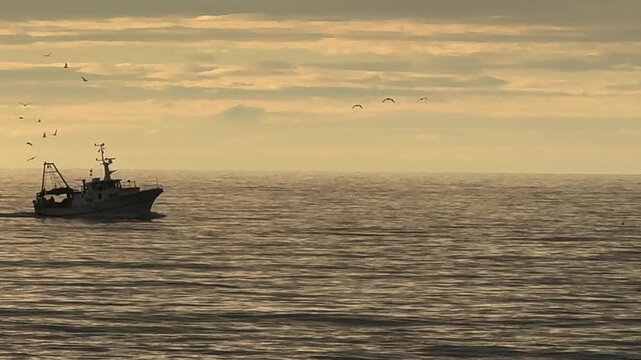 Fishing Boat Returns to Port After Fishing with Cloudy Sky